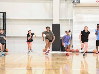 Players sprint across the court during a conditioning drill.